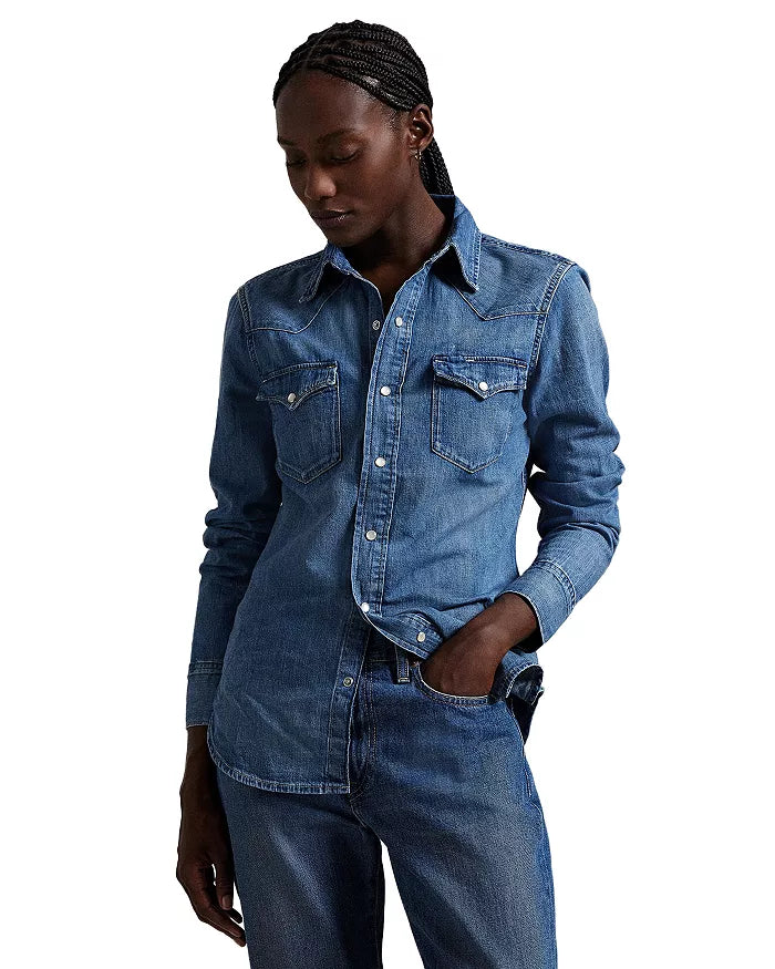 Person wearing a blue denim shirt and jeans on a white background