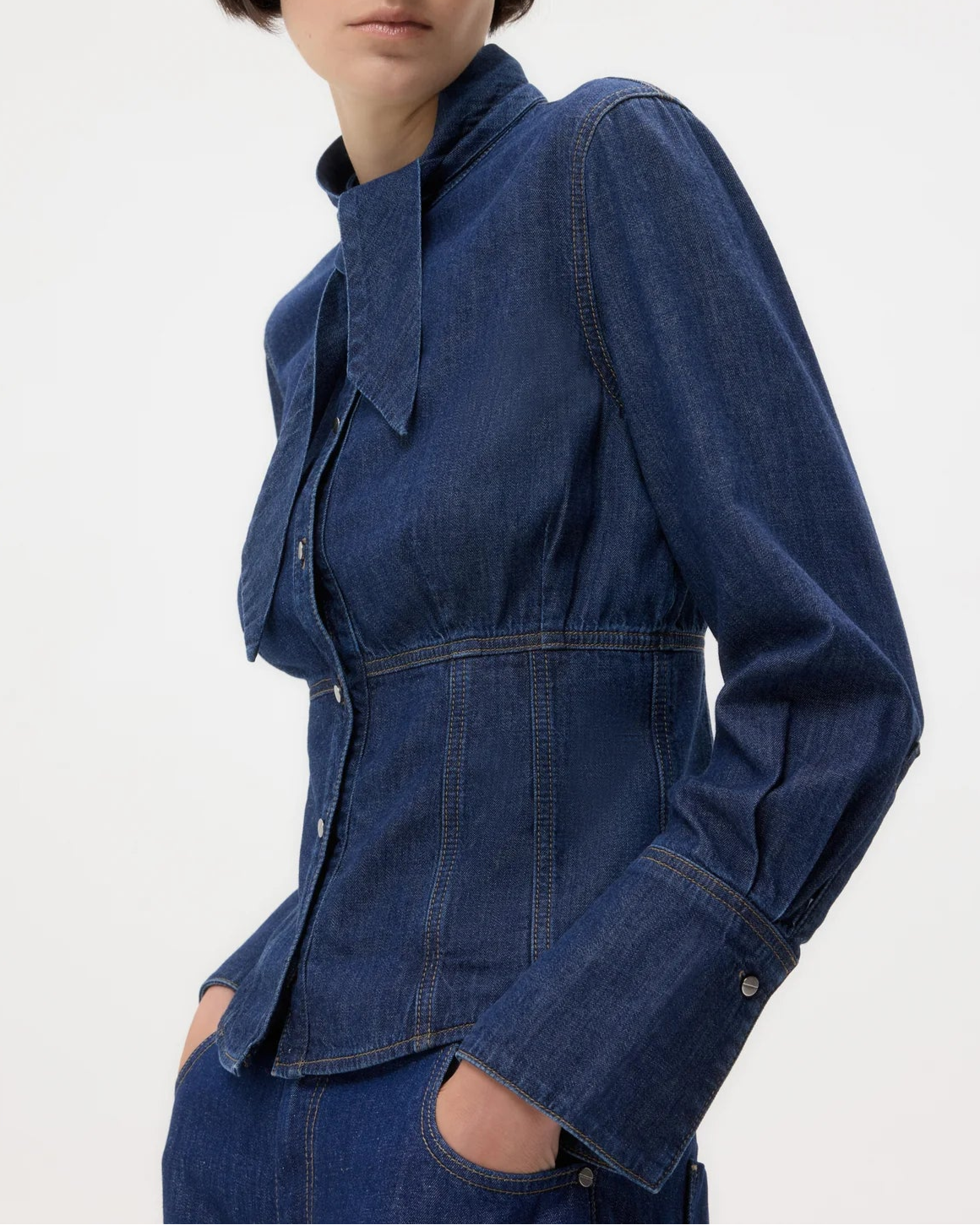 Woman wearing a blue denim jacket on a white background