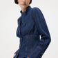 Woman wearing a blue denim jacket on a white background