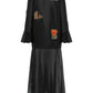Black dress with colorful patches on a white background
