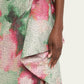 Close-up of a floral patterned fabric with pink and green colors.