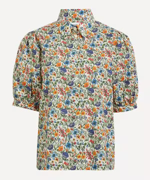 A short-sleeve button-up shirt with a dense, multicolor floral and botanical print on a light cream background, featuring puff sleeves and a pointed collar.