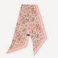 Floral patterned scarf with a brand label on a white background