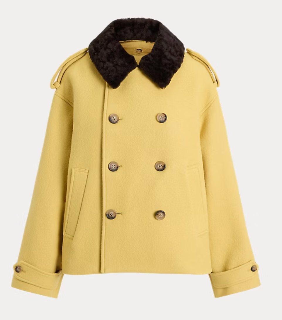 A yellow double-breasted coat with a dark brown faux-fur collar, displayed on a light gray background.